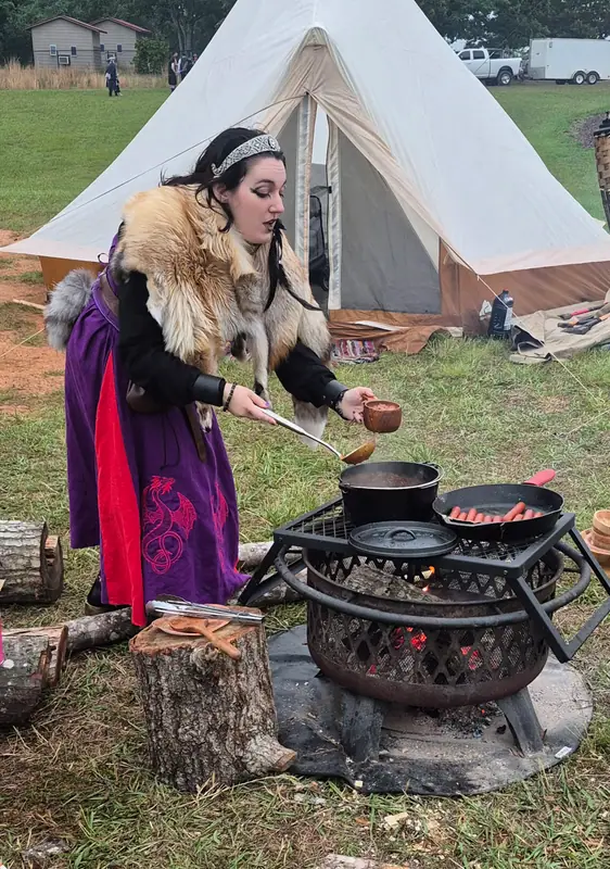 Members cooking over a fire at the encampment