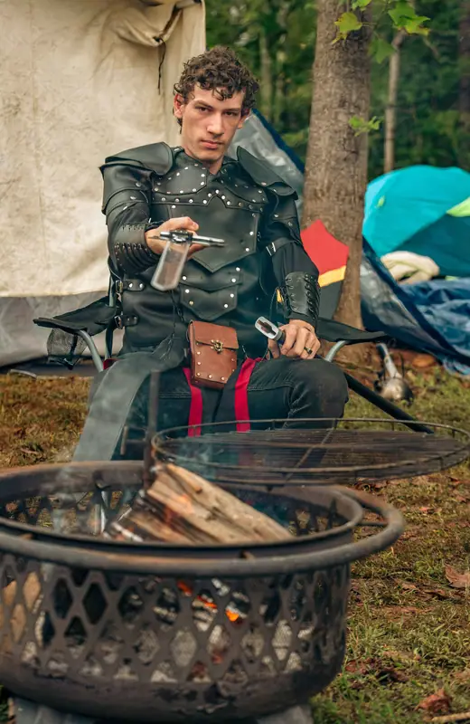 A member tending a fire at the camp