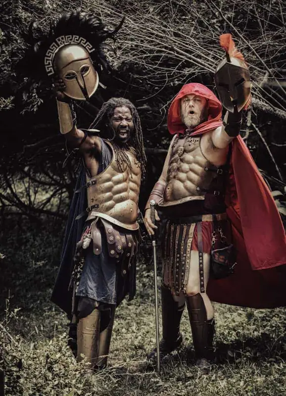 Two fighters in armor, one wearing a red cloak